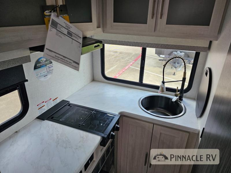 Forest River RV R Pod RP-194 travel trailer's kitchen with a high-rise faucet and circular sink, two burner stove, and plenty of cabinet space